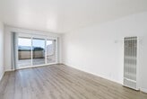 Located at 335 Talbot Ave in Pacifica, CA, this well-appointed one-bedroom, one-bathroom residence offers a thoughtfully organized single-floor layout. The living room features light wood laminate flooring and clean white walls, creating a bright and open atmosphere. Sliding glass doors lead directly to a private patio, framing stunning views of the surrounding hills — a standout feature that brings natural beauty into the heart of the living space.

The galley-style kitchen is efficiently designed with white cabinetry, ample upper and lower storage, a full suite of white appliances including a stove, refrigerator, and dishwasher, and a stainless steel sink with a view toward the patio. Adjacent to the kitchen, a dedicated dining room provides a natural space for meals and entertaining.

The carpeted bedroom offers a comfortable, cozy feel with a window overlooking lush greenery, a mirrored sliding-door closet, and convenient direct access to the bathroom. A hallway connects the main living areas and includes additional closet storage.

The full bathroom features wood-look flooring, a single vanity with stone-finish countertop, white cabinetry, a large mirror, and a shower-tub combination. Throughout, the unit maintains a clean, neutral palette that maximizes the sense of light and space.