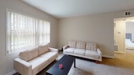 Located at 4815 Overland Pkwy in Toledo, Ohio, this single-floor home offers a well-organized layout designed for comfortable everyday living. The living room provides a welcoming gathering space, finished with plush carpeting, neutral-toned walls, and a large window fitted with vertical blinds that allow natural light to fill the room. The kitchen is thoughtfully equipped with rich, dark wood cabinetry, granite-style countertops, a stainless steel gas range, microwave, dishwasher, and refrigerator, all set atop light-toned tile flooring. Multiple bedrooms are present throughout the home, each carpeted and painted in soft, warm neutral tones. The bedrooms offer generous proportions, with windows that bring in outdoor light and views of the surrounding greenery. One bedroom features a built-in closet with shelving, providing practical storage. The bathroom is finished with large-format neutral wall tiles surrounding a full soaking tub and shower combination, complemented by a small frosted window above the tub that adds a touch of natural light. The overall ambiance of the home is clean, understated, and functional, making it a comfortable and move-in-ready residence in the Toledo area.