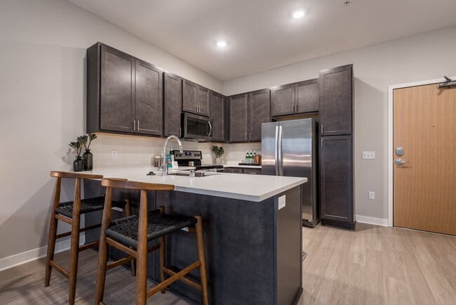 A modern kitchen with rich cabinetry and sleek finishes makes every meal feel like an experience. - The Preserve at Normandale Lake