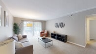 This well-appointed 2-bedroom, 2-bathroom residence in Clinton Township, Michigan offers a comfortable and functional single-floor layout. The living room is generously sized, featuring plush wall-to-wall carpeting, crown molding, and a large sliding glass door that fills the space with natural light and provides outdoor access. The adjacent dining area is defined by wood-look flooring and an elegant pendant light fixture, creating an inviting setting for meals and gatherings. The kitchen is well-equipped with dark espresso cabinetry, granite-style countertops, stainless steel appliances, and durable wood-look flooring, offering both style and practicality. Each bedroom is carpeted and outfitted with a ceiling fan, providing a restful retreat. The primary bedroom includes a closet with bifold doors and a window for natural light. Both bathrooms are finished with granite-topped dark vanities, tile flooring, and walk-in showers. A connecting hallway ties the layout together seamlessly, offering smooth flow throughout the home. The neutral color palette and consistent finishes throughout contribute to a cohesive and polished overall ambiance.