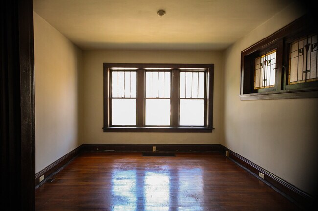 Living room with original woodwork & stained glass - 5204 Quincy St