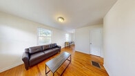 Located at 138 Grandview Ct in Ithaca, NY, this efficiently designed one-bedroom, one-bathroom unit offers a practical and functional layout across a single floor. Warm hardwood flooring runs throughout the living room, bedroom, dining room, and hallway, lending a cohesive and classic feel to the space.

The living room is a welcoming area bathed in natural light from two large windows that overlook the surrounding greenery, creating a bright and airy atmosphere. Adjacent to it, the dining room also features a window, further enhancing the sense of openness throughout the unit.

The bedroom is a cozy, well-proportioned room with its own window that brings in natural light and outdoor views of the tree-lined surroundings. Its clean, white walls provide a neutral and restful environment.

The galley-style kitchen is thoughtfully appointed with warm wood cabinetry, ample counter space, a stainless steel sink, and white appliances including a gas range and refrigerator. Tile flooring in the kitchen provides a practical, easy-to-clean surface.

The bathroom is a standout feature, showcasing floor-to-ceiling travertine-style tile surrounding a full soaking tub, accented by a decorative mosaic tile border that adds a refined touch. The overall layout is compact yet complete, making this unit a well-rounded living space in the heart of Ithaca.