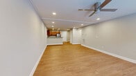 Located at 18 Stoneledge Drive in Troy, NY, this well-appointed single-floor home offers a thoughtfully designed layout with three bedrooms, two bathrooms, and an abundance of storage across five closets. The open-concept living and kitchen area serves as the heart of the home, featuring warm hardwood-style flooring, recessed lighting, crown molding, and a ceiling fan. The spacious living area provides ample room for both relaxing and entertaining, with a seamless flow into the kitchen. The kitchen is equipped with rich wood cabinetry, granite countertops, a peninsula with additional workspace, and a full suite of stainless steel appliances including a range, microwave, dishwasher, and refrigerator. The bedrooms are carpeted for comfort, with natural light provided by windows and generous closet space, including walk-in closets with built-in wire shelving systems. The bathrooms are finished with granite-topped vanities, wood cabinetry, and tile flooring, with at least one bathroom featuring a glass-enclosed walk-in shower. Additional conveniences include a dedicated laundry room and a utility room. The home's neutral color palette and clean finishes throughout create a bright, move-in-ready atmosphere.