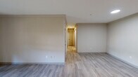Located at 5000 S Lincoln Trace Ave SE in Smyrna, Georgia, this thoughtfully designed single-floor residence offers three bedrooms, two bathrooms, a living room, kitchen, and a utility room — all within a well-proportioned layout. Light-toned wood-look flooring runs throughout, lending a clean and cohesive feel to the entire home.

The living room provides a bright, open entry point to the unit, with recessed lighting and a neutral color palette that maximizes the sense of space. The kitchen is well-appointed with white shaker-style cabinetry, a white subway tile backsplash, light countertops, and a full suite of stainless steel appliances including a refrigerator and dishwasher.

Each of the three bedrooms features wood-look flooring, a ceiling fan with light fixture, and a double-door closet offering generous storage. The primary bedroom is comfortably sized, while additional bedrooms benefit from natural light through windows with views of surrounding greenery.

Both bathrooms are finished with classic white subway tile surrounding deep soaking tub-shower combinations, complemented by chrome and brushed nickel fixtures. The clean, minimalist aesthetic throughout makes this a versatile and move-in ready home in the heart of Smyrna.