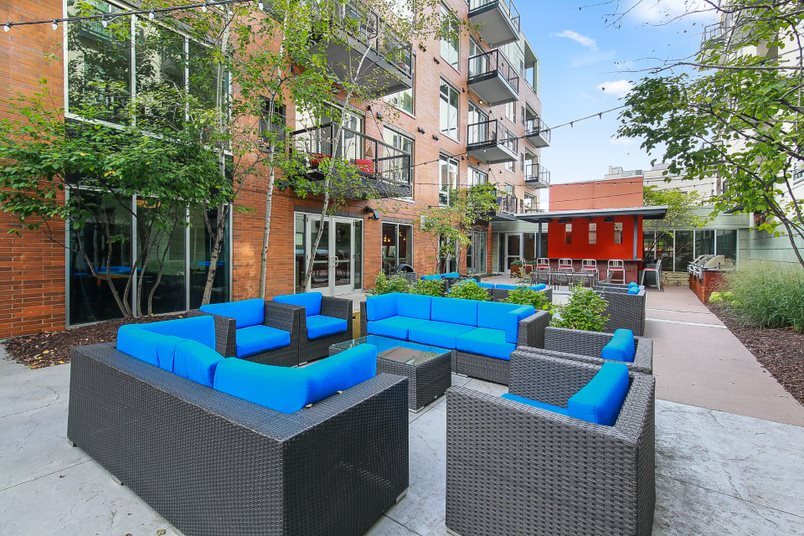 Courtyard seating area with blue cushions and outdoor bar.