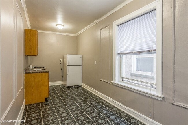 Functional galley-style kitchen perfect for everyday cooking. - 3935 W Diversey