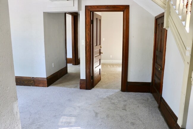 Living room and main level bedroom - 303 W Pleasant St