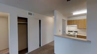 This single-floor, 1-bedroom, 1-bathroom residence is designed with everyday functionality in mind. The layout features a carpeted main living area that flows openly through the space, creating a cohesive and easy-to-navigate floor plan. A textured ceiling and ceiling fan add practical comfort to the living zone.

The kitchen is positioned adjacent to the living area, separated by a half-wall counter that provides a natural divide while maintaining an open feel. It is equipped with a gas range and oven, overhead cabinetry in warm wood tones, and under-cabinet lighting, offering a compact yet well-appointed cooking space.

The bedroom area benefits from generous built-in closet storage, featuring dual sliding-door closets that provide ample space for clothing and personal belongings. Neutral wall tones throughout the residence contribute to a clean, versatile aesthetic that adapts easily to a variety of interior styles.

HVAC vents are integrated into the ceiling, ensuring consistent climate control throughout the unit. The overall design is straightforward and practical, prioritizing storage, comfort, and efficient use of space — making it a solid option for individuals or couples seeking a manageable, move-in-ready living environment.