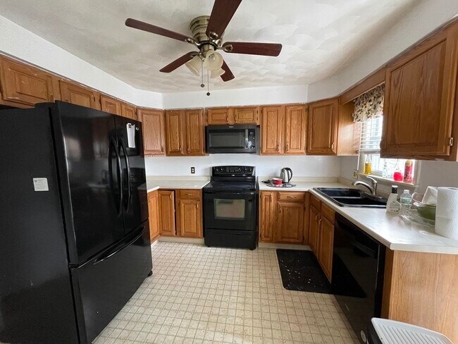 Kitchen with double sink, microwave, and dishwasher - 7 Millard Ave