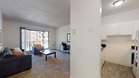 Located at 511 John Muir Dr in San Francisco's Lake Merced neighborhood, this single-floor unit offers a well-organized layout designed for comfortable everyday living. The living area is carpeted and features a large sliding glass door that fills the space with natural light while providing direct access to an outdoor area with views of the surrounding complex. The open layout comfortably accommodates a seating arrangement and a dedicated workspace.

Adjacent to the living area, the kitchen is efficiently designed with white cabinetry, dark countertops, a full-size refrigerator, and an electric range. A breakfast bar with seating for two bridges the kitchen and living space, creating a practical casual dining area.

The bedroom is carpeted and features large windows fitted with vertical blinds, allowing for adjustable natural light. The room offers ample space for a full-size bed and additional storage furniture.

The bathroom is clean and functional, finished with white tile and equipped with a full bathtub and shower combination. Throughout the unit, neutral white walls, textured ceilings, and consistent carpeting in the main living areas contribute to a cohesive, understated aesthetic.