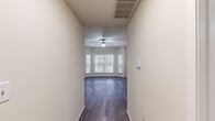 Located at 3323 McCue Rd in Houston's upscale Galleria neighborhood, this thoughtfully designed one-bedroom, two-bathroom residence offers a comfortable and functional single-floor layout. Rich, dark hardwood-style flooring runs consistently throughout the space, lending warmth and cohesion to every room.

The living room is a standout feature, showcasing a curved bay window configuration that floods the area with natural light. Crown molding and a ceiling fan add refined finishing touches to this inviting gathering space. A dedicated hallway connects the main living areas with ease.

The kitchen is well-equipped and visually striking, featuring dark espresso cabinetry, granite countertops, a mosaic tile backsplash, and a full suite of stainless steel appliances including a refrigerator, range, microwave, and dishwasher — ideal for everyday cooking and entertaining alike.

The spacious primary bedroom offers its own ceiling fan and a generous window for natural light, complemented by a dedicated closet for ample storage. Both bathrooms are clean and functional, with one featuring a full soaking tub and tiled surround. The overall aesthetic is neutral and modern, creating a versatile, move-in-ready environment throughout.