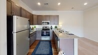Located at 139 Alexander Bank Dr. in Mooresville, NC, this single-floor residence offers a thoughtfully designed layout with a clean, contemporary aesthetic throughout. The kitchen is a standout space, featuring rich dark-toned cabinetry, granite countertops, stainless steel appliances including a range, microwave, and refrigerator, and a peninsula with bar seating — ideal for both meal prep and casual dining. Crown molding and recessed lighting add a refined finish to the kitchen area.

The living area is bright and open, with plush carpeting, neutral walls, and French doors that invite natural light and provide outdoor access. The bedrooms are generously sized, each carpeted and bathed in natural light from large windows with blinds. Multiple bedrooms feature access to closets and adjoining bathrooms, providing practical convenience.

Both bathrooms are well-appointed with dark wood vanities, white countertops, tub-shower combinations, and durable wood-look flooring that complements the warm, neutral color palette found throughout the residence. The overall ambiance is clean, modern, and move-in ready, offering a comfortable and functional living environment in the Mooresville community.