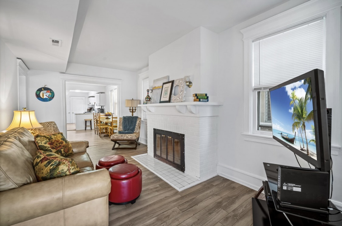 living room with brick fireplace - 5 N Newport Ave