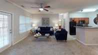 Located at 1460 Oakcrest Dr in Columbia, SC, this single-floor residence offers a well-designed layout with a comfortable blend of functionality and style. The living room is a welcoming centerpiece, featuring plush carpeting, a ceiling fan, crown molding, and generous natural light streaming through large windows with blinds. The adjoining dining area continues the refined aesthetic with chair-rail molding and carpet flooring, providing an ideal space for meals and gatherings. The kitchen is equipped with warm cherry-toned cabinetry, granite-style countertops, hardwood-look flooring, and ample storage on both sides of the galley-style layout. The space includes two bedrooms, each carpeted and filled with natural light. The primary bedroom benefits from a ceiling fan and direct access to a walk-in closet. Both bathrooms feature hardwood-look tile flooring and cherry wood vanities; one includes a shower-tub combination, while the other offers grab bars for added accessibility. A dedicated laundry room with wire shelving and space for a full-size washer and dryer adds everyday convenience. Throughout, neutral wall tones and consistent finishes create a cohesive and inviting atmosphere.