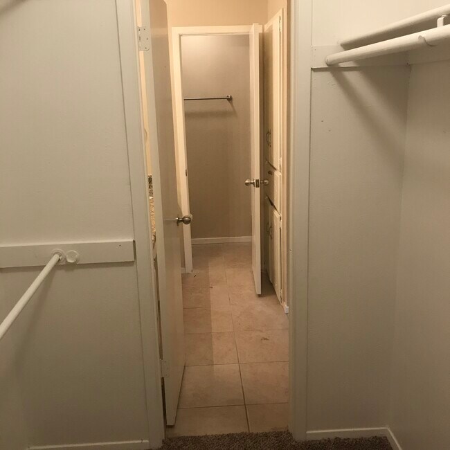 master bedroom walk in closet looking toward master bath - 2517 Warren Ln