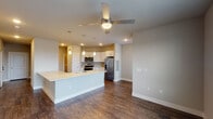 This 3-bedroom, 2-bathroom unit in College Station, TX offers a well-designed, single-floor layout that combines modern finishes with functional living spaces. The open-concept kitchen and living area serves as the heart of the home, featuring rich hardwood-style flooring, recessed lighting, and a ceiling fan overhead. The kitchen is outfitted with crisp white shaker-style cabinetry, a geometric tile backsplash, stainless steel appliances including a French door refrigerator, electric range, and over-the-range microwave, all complemented by a central island with a built-in sink and pendant lighting above. Natural light filters through large windows fitted with blinds, brightening both the living area and the bedrooms. The bedrooms are carpeted for comfort and each includes a ceiling fan and ample natural light. The two bathrooms are finished with wood-look tile flooring, neutral-toned large-format tile surrounds, white vanity cabinetry, and clean fixtures. One bathroom features a tub-shower combination, while the second offers a walk-in shower. The layout flows efficiently throughout, making this a comfortable and well-appointed residence.
