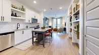 Located at 2370 Sever Rd in Lawrenceville, GA, this well-appointed 2-bedroom, 2-bathroom residence offers a thoughtfully designed layout across its single living floor. The open-concept kitchen and living area serves as the heart of the home, featuring white shaker cabinetry with matte black hardware, a classic subway tile backsplash, granite countertops, stainless steel appliances, and recessed lighting throughout. Light wood-style flooring flows seamlessly from the kitchen into the living area, which is anchored by large windows and a glass-panel door leading to a private balcony overlooking the surrounding landscape. The generously sized primary bedroom features plush carpeting, a bold accent wall, and ample natural light from oversized windows. Its en-suite bathroom includes a granite-topped vanity, a glass-enclosed walk-in shower, and direct access to a spacious walk-in closet fitted with wire shelving systems. The second bedroom is equally well-proportioned, also showcasing an accent wall and soft carpeting. The second bathroom mirrors the same refined finishes found throughout, with a granite vanity and clean, neutral tiling. A connecting hallway and additional closet space round out the practical layout of this modern, move-in-ready residence.