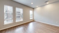 Located at 1001 W Rosedale St in Fort Worth, TX, this thoughtfully designed single-floor unit offers a cohesive modern aesthetic throughout. Light wood-tone luxury vinyl plank flooring runs continuously across the space, creating a warm and unified look.

The galley-style kitchen is a standout feature, outfitted with stainless steel appliances including a refrigerator, electric range, over-the-range microwave, and dishwasher. Warm wood cabinetry extends floor to ceiling, maximizing storage, while granite countertops and a textured slate-style tile backsplash add refined detail. A single-basin sink with a matte black faucet completes the functional layout.

The living and sleeping areas are bright and open, benefiting from multiple windows that invite natural light and views of the surrounding neighborhood. Neutral warm-toned walls and recessed lighting keep the atmosphere clean and inviting, while a ceiling fan adds comfort to the bedroom area.

The bathroom mirrors the kitchen's quality finishes, featuring a granite-topped vanity with warm wood cabinetry, an undermount sink, brushed nickel fixtures, and a well-lit mirror. Two closets provide generous storage to complement the efficient floor plan. The entry area flows seamlessly from the kitchen, reinforcing the unit's smart, open layout.