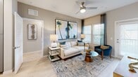 Located at 3010 Swinley Blvd in Davenport, Florida, this well-appointed 2-bedroom, 2-bathroom single-story residence offers a thoughtfully designed layout with a bright, contemporary aesthetic. Light wood-style flooring flows throughout, complementing the neutral color palette that defines the space.

The open-concept kitchen is a standout feature, showcasing gray shaker-style cabinetry, quartz countertops, a white subway tile backsplash, stainless steel appliances, and a center island with pendant lighting — ideal for both cooking and casual dining. The kitchen flows seamlessly into the living area, which is bathed in natural light from large windows and accented by a ceiling fan.

The spacious primary bedroom features a teal accent wall, large windows with stylish drapery, ceiling fan, and a dedicated walk-in closet with built-in wire shelving. Its en-suite bathroom includes gray vanity cabinetry, quartz countertops, and a glass-enclosed shower. The second bedroom is equally well-appointed, with its own adjacent bathroom featuring a tiled shower and matching vanity finishes.

Two closets provide ample storage throughout the residence. A connecting hallway ties the layout together efficiently, creating a functional and comfortable living environment with a clean, modern Florida aesthetic.