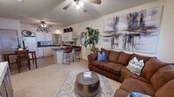 This one-bedroom, one-bathroom residence in Tuscaloosa, Alabama offers a well-designed layout that maximizes every square foot. The open-concept living and kitchen area forms the heart of the home, creating a seamless flow between spaces. The living room features vaulted ceilings, a ceiling fan with light fixture, and a large window that brings in natural light, lending the space an airy, welcoming feel.

The kitchen is equipped with white cabinetry, dark countertops, a full suite of white appliances including a range, microwave, dishwasher, and refrigerator. A peninsula with bar seating provides a casual dining option and further connects the kitchen to the living area. Tile flooring grounds this zone, transitioning to carpet in the living and sleeping areas.

The generously sized bedroom features vaulted ceilings, a ceiling fan, and a large window allowing ample natural light. A dedicated closet provides organized storage. The bathroom is clean and functional, featuring a single vanity with mirror, tile flooring, and a shower-tub combination with sliding glass doors.

Throughout the residence, ceiling fans are present in each main room, contributing to comfort year-round. The layout is practical and efficient, making this a comfortable and well-appointed home in the Links Blvd community.