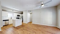 This contemporary 610 sq ft apartment in Oklahoma City offers a thoughtfully designed living space. The open floor plan seamlessly connects the living area to the kitchen, creating a spacious feel. The living room is highlighted by French doors that open to a balcony, allowing natural light to flood the space. The kitchen boasts modern white cabinetry, stainless steel appliances, and a hexagonal tile backsplash, complemented by a center island for additional workspace.

The 140 sq ft bedroom features plush carpeting and a ceiling fan, providing comfort and airflow. The bathroom is efficiently designed with a shower/tub combination and a single vanity. Throughout the apartment, warm wood flooring adds a touch of elegance, contrasting beautifully with the neutral wall colors.

Additional features include recessed lighting, a hallway closet for extra storage, and a ceiling fan in the main living area. The apartment's layout maximizes functionality, making it an ideal choice for those seeking a compact yet stylish urban dwelling in the heart of Oklahoma City.