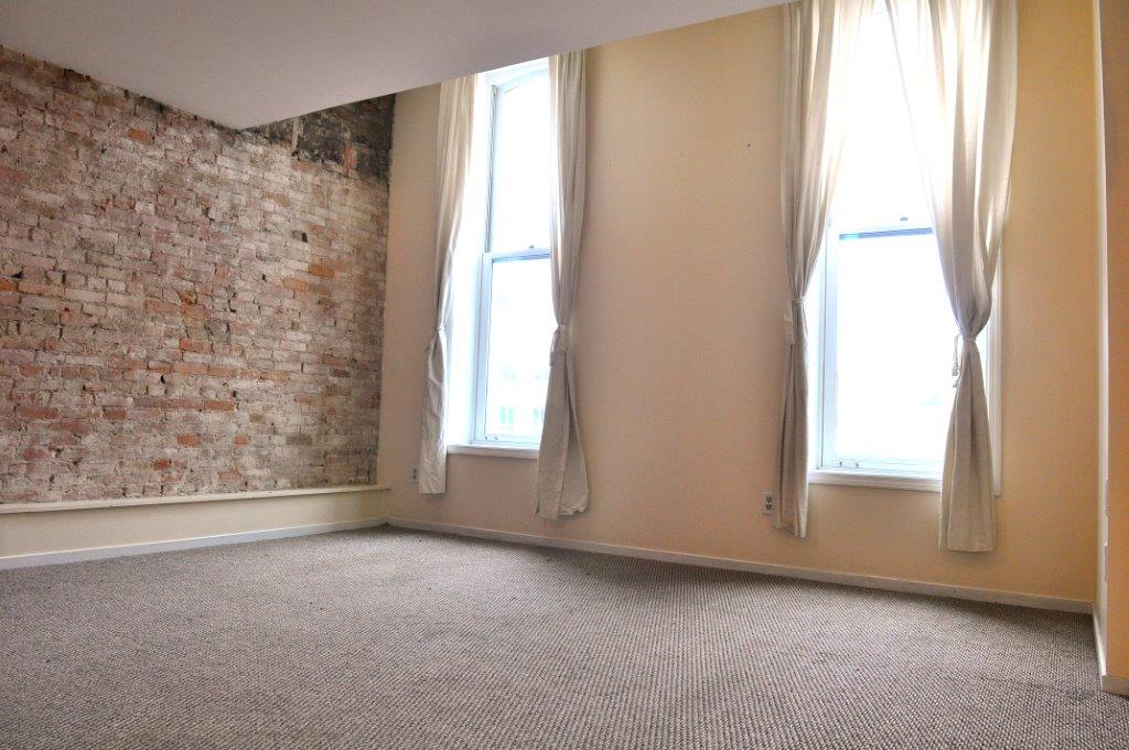 Front living area with large windows - 112 W Michigan Ave