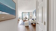 This well-appointed 2-bedroom, 2-bathroom residence in Bowling Green, Kentucky offers a thoughtfully designed single-floor layout that maximizes comfort and functionality. The open-concept living and dining area serves as the heart of the home, featuring warm wood-style flooring, a textured ceiling, and a bold blue accent wall that adds a distinctive design element. Large windows dressed with patterned curtains fill the space with natural light, creating a bright and welcoming ambiance throughout.

The galley-style kitchen is outfitted with white shaker cabinetry, granite countertops, a white subway tile backsplash, and stainless steel appliances, offering both style and practicality. The adjacent dining area benefits from direct outdoor access through a glass-panel door, flooding the space with additional natural light.

The primary bedroom is generously sized and features plush carpeting and a dedicated walk-in closet. The bathrooms are finished with white vanity cabinetry, granite countertops, and wood-framed mirrors with modern vanity lighting. A dedicated in-unit laundry room provides added convenience. Two closets throughout the residence offer ample storage, rounding out this functional and attractive home.