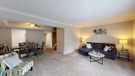 Located at 7950 Village Drive in Cincinnati, Ohio, this two-story home offers a thoughtfully designed layout across two well-proportioned floors. The main level welcomes you through a dedicated entrance that opens to a carpeted living room adorned with crown molding and soft, warm lighting. Adjacent to the living room, the dining area features a tray ceiling with a ceiling fan and flows directly into the kitchen, which is equipped with light wood cabinetry and ample counter space. A bathroom on the main level adds everyday convenience.

The upper floor hosts both bedrooms, including a generously sized primary bedroom with plush carpeting, a large window that invites natural light and outdoor views, and ample closet access. The second bedroom is equally comfortable, with neutral tones and good proportions. The upper level is served by two additional bathrooms, one of which features a full tub and shower combination. A carpeted hallway connects the bedrooms, with a staircase providing easy access between floors.

Throughout the home, neutral gray walls, textured ceilings, and durable flooring choices create a cohesive and move-in-ready aesthetic. With eight closets distributed across both levels, storage is a clear strength of this home.