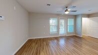 Located at 5004 Dream Dr in Winter Haven, Florida, this single-story, 2-bedroom, 2-bathroom home offers a thoughtfully designed open-concept layout with modern finishes throughout. Light wood-look flooring flows seamlessly across every room, complementing the home's clean, contemporary aesthetic.

The kitchen is a standout feature, boasting crisp white shaker cabinetry, granite countertops, a center island, and a full suite of stainless steel appliances, including a range, built-in microwave, and dishwasher. The adjacent living room is bright and welcoming, with large windows, a ceiling fan, and a glass door that fills the space with natural light and greenery views.

Both bedrooms are generously proportioned, each featuring large windows with outdoor views and dedicated closets equipped with wire shelving systems. The spacious primary bedroom includes its own en-suite bathroom, which features a double-sink vanity with granite countertops, white cabinetry, and a walk-in shower. The second bathroom offers a single vanity with matching granite countertops.

A dedicated laundry room houses a full-size washer and dryer, adding everyday convenience. A connecting hallway ties all spaces together efficiently. This home combines practical amenities with polished design details for comfortable Florida living.