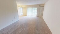 Located at 2122 Haven Rd, Apt. A in Wilmington, Delaware, this single-floor apartment offers a practical and comfortable layout with two bedrooms and two full bathrooms. The living area is generously proportioned, featuring neutral-toned wall-to-wall carpeting and a sliding glass door dressed with vertical blinds that allows natural light to fill the space. The open, clean aesthetic throughout creates a bright and inviting ambiance.

The spacious primary bedroom continues the soft carpeted flooring and includes a built-in closet with integrated shelving, providing ample storage. The second bedroom also features carpeting and a window with vertical blinds, offering a similarly bright and versatile space.

The kitchen is equipped with light wood cabinetry, dark countertops, tile flooring, and a full-size refrigerator. A doorway from the kitchen leads to a dedicated pantry or utility closet with built-in shelving for additional storage convenience.

Both bathrooms are well-appointed; one features tile flooring, a walk-in shower with sliding glass doors, a white vanity with under-cabinet storage, and overhead cabinetry. The neutral color palette used throughout the unit — warm beige walls paired with white trim — lends a clean and cohesive look to every room.