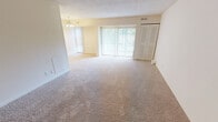 Located at 2122 Haven Rd, Apt. A in Wilmington, Delaware, this single-floor apartment offers a practical and comfortable layout with two bedrooms and two full bathrooms. The living area is generously proportioned, featuring neutral-toned wall-to-wall carpeting and a sliding glass door dressed with vertical blinds that allows natural light to fill the space. The open, clean aesthetic throughout creates a bright and inviting ambiance.

The spacious primary bedroom continues the soft carpeted flooring and includes a built-in closet with integrated shelving, providing ample storage. The second bedroom also features carpeting and a window with vertical blinds, offering a similarly bright and versatile space.

The kitchen is equipped with light wood cabinetry, dark countertops, tile flooring, and a full-size refrigerator. A doorway from the kitchen leads to a dedicated pantry or utility closet with built-in shelving for additional storage convenience.

Both bathrooms are well-appointed; one features tile flooring, a walk-in shower with sliding glass doors, a white vanity with under-cabinet storage, and overhead cabinetry. The neutral color palette used throughout the unit — warm beige walls paired with white trim — lends a clean and cohesive look to every room.