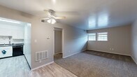 Located at 6729 Ramblewood Dr in Fort Wayne, Indiana, this single-story home offers three bedrooms and one bathroom in a practical, efficient layout. The main living area features a ceiling fan with integrated lighting, neutral gray walls, and a combination of plush carpet and luxury vinyl plank flooring that transitions throughout the space. A floor-mounted HVAC vent and wall thermostat ensure year-round comfort. Windows along one wall allow natural light to brighten the open area. The spacious primary bedroom is generously sized, featuring carpet flooring, dual windows that invite natural light, and direct access to the shared bathroom. The additional bedrooms also feature carpet flooring and neutral-toned walls, offering versatile spaces for various uses. The bathroom is well-appointed with a vanity, toilet, and a shower/tub combination. The kitchen stands out with white shaker-style cabinetry, dark countertops, black appliances including a range and dishwasher, and light-toned LVP flooring that ties the space together cleanly. A dedicated closet rounds out the functional layout of this straightforward and move-in ready home.