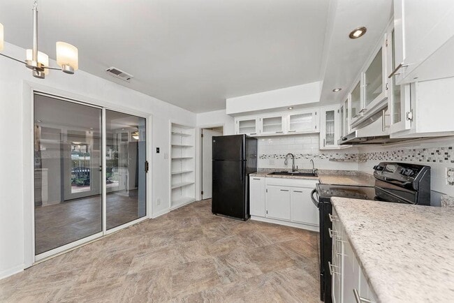 Beautiful, updated kitchen with glass front cabinets and tons of storage! All appliances - including range, refrigerator, dishwasher. Kitchen opens to Sunroom, charming patio and fully fenced back yard. - 11 Lawndale Ave