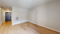 This efficiently designed studio unit at 5522 7th Ave in Kenosha, Wisconsin offers a well-organized single-floor layout that makes the most of its compact footprint. The open-concept living and kitchen area is anchored by light hardwood flooring that extends throughout the space, creating a warm and cohesive feel. The kitchen is a standout feature, equipped with rich dark wood cabinetry, bright white countertops with an angled peninsula, and a full suite of stainless steel appliances including a gas range, built-in microwave, dishwasher, and refrigerator. Recessed lighting illuminates the kitchen area, while a large sliding glass door allows natural light to fill the living space and provides access to the outdoors. A dedicated pantry offers additional storage to complement the kitchen cabinetry. The bathroom is clean and functional, featuring a tub-shower combination with a white surround, a vanity with white countertop, and matte black fixtures and hardware throughout. The neutral, light-toned walls throughout the unit lend a fresh and modern aesthetic, while the electrical panel is conveniently recessed into the wall of the main living area. This unit is a practical and modern space well-suited for single occupancy.