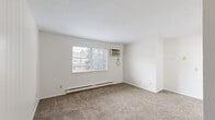 Located at 4717 Cleveland Ave NW in Canton, Ohio, this single-floor, 2-bedroom, 1-bathroom unit offers a straightforward and functional layout. The space is designed with practicality in mind, making efficient use of its compact footprint.

The primary bedroom is the largest room in the unit, featuring wall-to-wall carpeting, a ceiling fan with light fixture, a window that allows natural light and outdoor views of surrounding greenery, a built-in closet with louvered doors, and a baseboard heating system. The second bedroom also features carpeting, a ceiling fan, a window with natural light, and baseboard heating, providing a comfortable and consistent feel throughout.

The living area is carpeted and features vertical wall paneling, offering a cozy atmosphere. A wall-mounted air conditioning unit is present in one of the rooms, supplementing the baseboard heat system found throughout the unit.

The bathroom is clean and well-appointed, featuring white square tile in the tub/shower surround, a standard tub, a toilet, and a wood-toned vanity with a light countertop and integrated sink, all set on neutral large-format tile flooring.

The kitchen, visible in the floor plan, includes dark wood cabinetry and a range, rounding out this practical and livable unit.