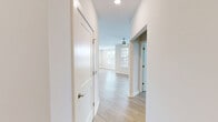 This well-appointed two-bedroom, two-bathroom apartment on Walmsley Boulevard in Richmond, Virginia offers a thoughtfully designed single-floor layout with a clean, modern aesthetic. Light wood-style flooring runs throughout the entire unit, creating a cohesive and bright atmosphere.

The open-concept kitchen and living area serves as the heart of the home. The kitchen features rich dark-wood cabinetry, granite countertops, stainless steel appliances including a refrigerator, range, and built-in microwave, and a peninsula island with sink — ideal for both cooking and casual dining. Recessed lighting illuminates the space, while large windows fitted with blinds invite natural light into the adjoining living area, which also provides direct access to a private balcony with outdoor views.

Both bedrooms are generously sized, each equipped with a ceiling fan and windows offering neighborhood views. The primary bedroom includes a double-door closet. The two bathrooms mirror the kitchen's design language, featuring dark-wood vanities, granite countertops, and brushed nickel fixtures. One bathroom includes a walk-in shower.

A dedicated in-unit laundry room houses a full-size front-loading washer and dryer. Hallways connect all spaces efficiently, completing this functional and contemporary layout.