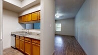 Located in Austin, TX (78741), this single-story, one-bedroom, one-bathroom unit offers a functional and efficient layout across a compact but well-organized floor plan. The living room serves as the heart of the space, featuring durable wood-style flooring, a ceiling fan with light fixture, a textured ceiling, and multiple windows fitted with blinds that allow ample natural light. A glass-panel door provides direct access to the exterior, further brightening the area.

The kitchen is semi-open and separated from the living area by a partial wall, creating a defined yet connected feel. It is outfitted with warm-toned wooden cabinetry, granite-style countertops, a stainless steel dishwasher, and a double-basin sink — offering practical functionality for everyday cooking.

The bedroom is a comfortable, well-proportioned room with the same wood-style flooring, a ceiling fan, a window for natural light, and neutral-toned walls that provide a clean, versatile backdrop.

The bathroom includes a single vanity with granite-style countertops, wooden cabinetry, a framed mirror, and wood-style flooring that ties the space together cohesively.

Throughout the unit, consistent neutral tones, textured ceilings, and wood-style flooring create a cohesive and low-maintenance aesthetic suited for comfortable everyday living in Austin.
