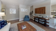 Located at 1731 Tupelo Hill Ln in Raleigh, NC, this single-floor residence offers a thoughtfully designed layout with a cohesive neutral palette and quality finishes throughout. The kitchen is well-equipped with white shaker cabinetry, granite countertops, a gray subway tile backsplash, stainless steel appliances, and wood-look flooring, opening toward a bright dining area framed by large windows with elegant drapery. The living room features the same durable wood-look flooring, built-in shelving detail, and ample natural light, creating a warm and inviting atmosphere. The primary bedroom is generously sized with plush carpeting, a ceiling fan, and a window with views to the exterior. Its en-suite bath is elegantly appointed with large-format tile flooring, a granite vanity with white cabinetry, and a glass-enclosed shower, leading directly into a spacious walk-in closet with wire shelving. A second bedroom also offers carpeted flooring, a ceiling fan, and its own walk-in closet. A dedicated laundry area with overhead shelving adds practical convenience. Throughout the home, neutral gray tones, clean architectural lines, and carefully chosen finishes contribute to a polished and comfortable living environment.