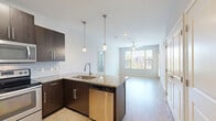 Located at 8201 Quivira Rd in Lenexa, Kansas, this 2-bedroom, 2-bathroom residence offers a thoughtfully designed single-level floor plan with modern finishes throughout. The open-concept kitchen serves as the heart of the home, showcasing dark espresso cabinetry, granite countertops, a subway tile backsplash, and stainless steel appliances including a French door refrigerator, electric range, microwave, and dishwasher. A peninsula with pendant lighting provides additional prep space and flows seamlessly into the living area, which features light hardwood-style flooring, a ceiling fan, and windows that invite natural light. The primary bedroom offers comfortable carpeting, a ceiling fan, and direct access to a private en-suite bathroom featuring a double-sink granite vanity with dark cabinetry, wood-look flooring, and a walk-in shower. A spacious walk-in closet with wire shelving provides generous storage. The second bedroom is equally well-lit, with a large window offering outdoor views and plush carpeting. The second bathroom includes a soaking tub and shower combination with built-in shelving. Both closets feature multi-tier wire shelving systems, maximizing storage efficiency throughout this well-planned residence.