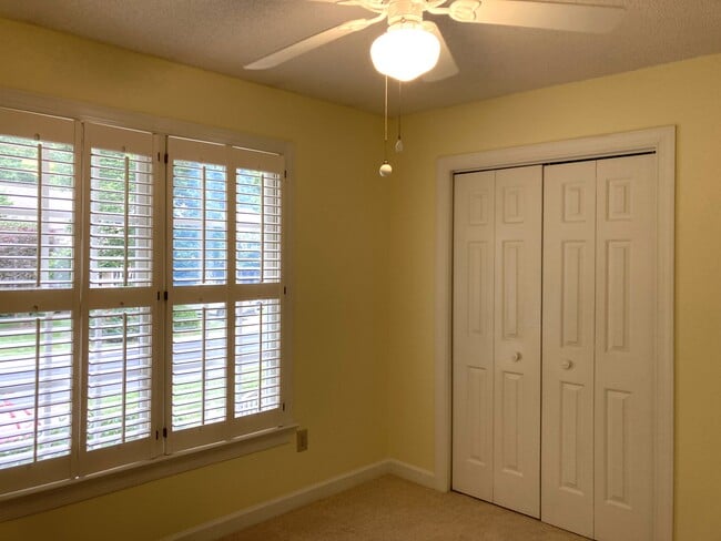 Bedroom features plantation shutters and a spacious closet - 1243 Cranebridge Pl