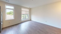 Located at 1017 E Hamilton St in Milwaukee, WI, this single-floor unit offers a thoughtfully designed open-concept layout that seamlessly connects the living and kitchen areas. Light-toned hardwood-style flooring runs throughout the main living spaces, creating a clean, cohesive aesthetic and a sense of generous openness.

The kitchen is a standout feature, outfitted with rich, dark espresso cabinetry paired with stone-patterned countertops that offer ample prep space. A full suite of stainless steel appliances — including a refrigerator, electric range, over-the-range microwave, and dishwasher — rounds out the well-equipped cooking space. Track lighting above the kitchen and recessed lighting throughout enhance both function and ambiance.

The bedroom is a bright, tranquil retreat with neutral walls and natural light streaming in through windows overlooking greenery. The room connects to a spacious walk-in closet with wire shelving and carpeted flooring, providing generous storage capacity.

The bathroom features light tile flooring, a dark vanity cabinet with stone-finish countertop, and a large mirror — delivering a polished, modern feel. The overall design of this unit balances contemporary finishes with practical functionality, making it an attractive and comfortable urban residence.
