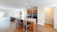 Located at 4926 Becker Dr in Allendale, MI, this three-bedroom, four-bathroom residence spans three floors, offering a well-organized and functional layout. The main living floor features an open-concept design that connects the kitchen, dining, and living areas into a single cohesive space. The kitchen is equipped with warm-toned cabinetry, granite countertops, black appliances including a refrigerator, range, and microwave, and a central island with seating — ideal for casual dining. The living area extends to a sliding glass door with vertical blinds that opens to an outdoor view of the backyard, allowing natural light to flow through the space. Hardwood-style flooring runs throughout all levels, lending a consistent and polished look. Each bedroom is comfortably sized, featuring windows with blinds and dedicated closet space, with several closets outfitted with wire shelving systems for organized storage. The bathrooms feature granite-topped vanities and tub-shower combinations. A dedicated in-unit laundry room with a full-size washer and dryer adds everyday convenience. With three staircases connecting the floors and a thoughtful distribution of rooms across each level, this residence offers both practicality and comfortable living in a clean, modern aesthetic.
