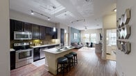 Located at 10300 Katy Freeway in Houston, TX, this 2-bedroom, 3-bathroom residence offers a thoughtfully designed open-concept floor plan that maximizes every square foot. Rich hardwood-style flooring flows through the main living areas, connecting the kitchen, dining, and living spaces in a seamless layout. The gourmet kitchen is a standout feature, showcasing dark espresso cabinetry, granite countertops, stainless steel appliances, tile backsplash, and a center island with bar seating — all illuminated by pendant lighting and a rail track system overhead. The adjacent living room is bright and welcoming, featuring a bold accent wall, large windows that invite natural light, and a ceiling fan. The primary bedroom offers a serene retreat with a dramatic navy accent wall, plush carpeting, and an en-suite bathroom complete with a granite double vanity, dark cabinetry, and a walk-in closet with built-in shelving. The second bedroom is equally comfortable, with carpet flooring, natural light, and balcony access. Additional bathrooms feature granite vanities and tub-shower combinations. A stacked in-unit washer and dryer adds everyday convenience, while four closets provide generous storage throughout.