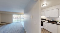 This one-bedroom, one-bathroom residence in Southfield, Michigan is thoughtfully laid out across a single floor, offering a comfortable and efficient use of space throughout. The entrance opens into a hallway that connects the main living areas, creating a natural flow through the home. The combined dining and living room is a standout feature, highlighted by large sliding glass doors that flood the space with natural light and provide views of the outdoors. Plush carpet underfoot adds warmth, while a dedicated dining area features wood-look flooring and an elegant pendant light fixture overhead. The kitchen is well-appointed with crisp white cabinetry, dark countertops, wood-look flooring, and a full suite of appliances including a range and refrigerator. It connects seamlessly to the rest of the home via an open passageway. The generously sized bedroom offers carpeted flooring, a large window for natural light, and access to two closets, providing ample storage. The bathroom is clean and functional, featuring white cabinetry with dark countertops, a large vanity mirror, tile flooring, and a shower-tub combination. Two additional closets throughout the home offer practical storage solutions to complement this well-organized living space.