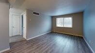 Located at 670 Prospect St in Berea, Ohio, this single-floor, one-bedroom, one-bathroom unit offers a practical and well-organized layout. The open combined living and dining area is finished with durable wood-look vinyl plank flooring and neutral gray walls, creating a clean, modern feel. A large window allows natural light to flow throughout the space, offering views of the surrounding neighborhood. The living area provides ample room for both relaxing and dining, with convenient access to additional rooms via a paneled interior door.

The kitchen is equipped with white appliances, including a refrigerator and range, set against wood-toned cabinetry — a functional setup for everyday cooking. The bedroom features plush carpeting, a ceiling fan with light fixture, and a window that continues the theme of natural light throughout the unit. Three closets provide generous storage solutions across the floor plan, complemented by a dedicated utility room.

The bathroom is a standout feature, showcasing a full tub and shower surround finished in large-format, marble-veined ceramic tile in soft neutral tones, paired with polished chrome fixtures for a clean, updated look. Throughout the unit, gray-toned walls, white trim, and consistent finishes contribute to a cohesive and move-in-ready aesthetic.