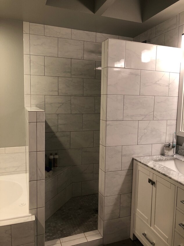 fully remodeled master bathroom with granite and tile and sky light. - 9915 NE 124th St