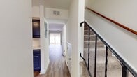This two-story townhouse in the Commons At Windsor Gardens offers a well-designed living space of 900 square feet. The layout comprises 2 bedrooms, 1 bathroom, a kitchen, a living room, and two staircases connecting the floors. The primary bedroom is generously sized at 170 square feet, providing ample space for comfort and storage.

The interior showcases a variety of flooring options, adding character to each room. Some areas feature warm, polished hardwood floors in a parquet pattern, while others have modern vinyl or laminate flooring. The bathroom is fitted with clean, white tile flooring.

Natural light floods the rooms through windows equipped with horizontal blinds, creating a bright and airy atmosphere. The living areas have crisp, white walls that contribute to the sense of spaciousness and offer a blank canvas for personalization.

The bathroom is efficiently designed with a combined tub and shower unit, featuring white fixtures and built-in storage niches. The kitchen, though not fully visible in the images, appears to be open to the living area, promoting a sense of flow throughout the main floor.

Built-in closets with sliding doors provide essential storage space in the bedrooms. The property's split-level design, with 500 square feet on the ground floor and 410 square feet on the upper level, offers a clear separation between living and sleeping areas.

Overall, this townhouse presents a modern, low-maintenance living option with a practical layout and neutral decor, suitable for various lifestyle needs.