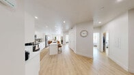 Located in the Desert Color community of Saint George, Utah, this well-designed 3-bedroom, 2-bathroom single-story home offers a bright, modern interior with a cohesive open-concept layout. Light wood-tone flooring flows throughout, complementing the crisp white walls and recessed lighting that keep the space feeling airy and inviting.

The kitchen is a standout feature, showcasing white shaker cabinetry, stainless steel appliances, a subway tile backsplash, and a central island with bar seating — ideal for both everyday living and entertaining. It connects seamlessly to a spacious living room, which is bathed in natural light and opens to a front entrance with double doors.

The primary bedroom is generously sized, featuring sliding glass door access to an outdoor area, a large window framing views of the surrounding desert landscape, a ceiling fan, and a dedicated walk-in closet with built-in shelving and drawers. Additional bedrooms are well-proportioned and bright, each with natural light. The bathrooms are cleanly finished, with one featuring a tub-shower combination.

A pantry provides additional storage, rounding out a practical and polished floor plan. The overall ambiance is calm and contemporary, perfectly suited to the sunny Southern Utah setting.