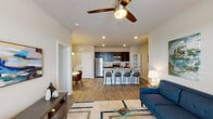 This 1-bedroom, 1-bathroom unit is thoughtfully designed with an open-concept layout that seamlessly connects the living, dining, and kitchen areas. Wood-style plank flooring flows throughout, complemented by neutral wall tones and recessed lighting that create a warm, inviting atmosphere.

The kitchen is a standout feature, showcasing dark espresso cabinetry, granite countertops, a white subway tile backsplash, and a full suite of stainless steel appliances including a refrigerator, range, and built-in microwave. A peninsula with bar seating provides additional prep space and casual dining options, while a dedicated pantry offers generous storage.

The dining area is positioned adjacent to the kitchen and is illuminated by a modern pendant light, making it an ideal spot for everyday meals. The living room is bright and airy, featuring a ceiling fan, large French doors that invite natural light, and ample space for comfortable furnishings.

The bedroom is a serene retreat with a ceiling fan, windows with natural light, and wood-style flooring. The full bathroom is spacious and includes a tub-shower combination and hardwood-style flooring. An in-unit laundry area adds everyday convenience, rounding out this well-equipped and functional home.