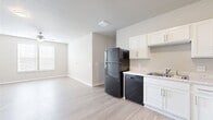 This 850 square foot apartment in Bettendorf, Iowa, offers a blend of comfort and modern living. The single-story layout comprises two bedrooms, including a primary bedroom of 180 square feet, and one bathroom. The open-concept design features a combined kitchen and living room area, creating a spacious feel. The kitchen boasts white cabinetry, sleek black appliances, and light-colored countertops, complemented by wood-look flooring. Both bedrooms are equipped with ceiling fans and large windows, providing natural light and air circulation. The bathroom is fitted with a shower-tub combination and modern fixtures. Throughout the apartment, neutral-toned walls and carpeting in select areas create a clean, contemporary ambiance. A hallway and closet offer additional storage solutions. The apartment's design emphasizes functionality and comfort, making it an ideal living space for individuals or small families seeking a modern, low-maintenance home in a convenient Iowa location.